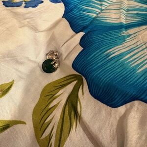 silver cat pendant with large green crystal